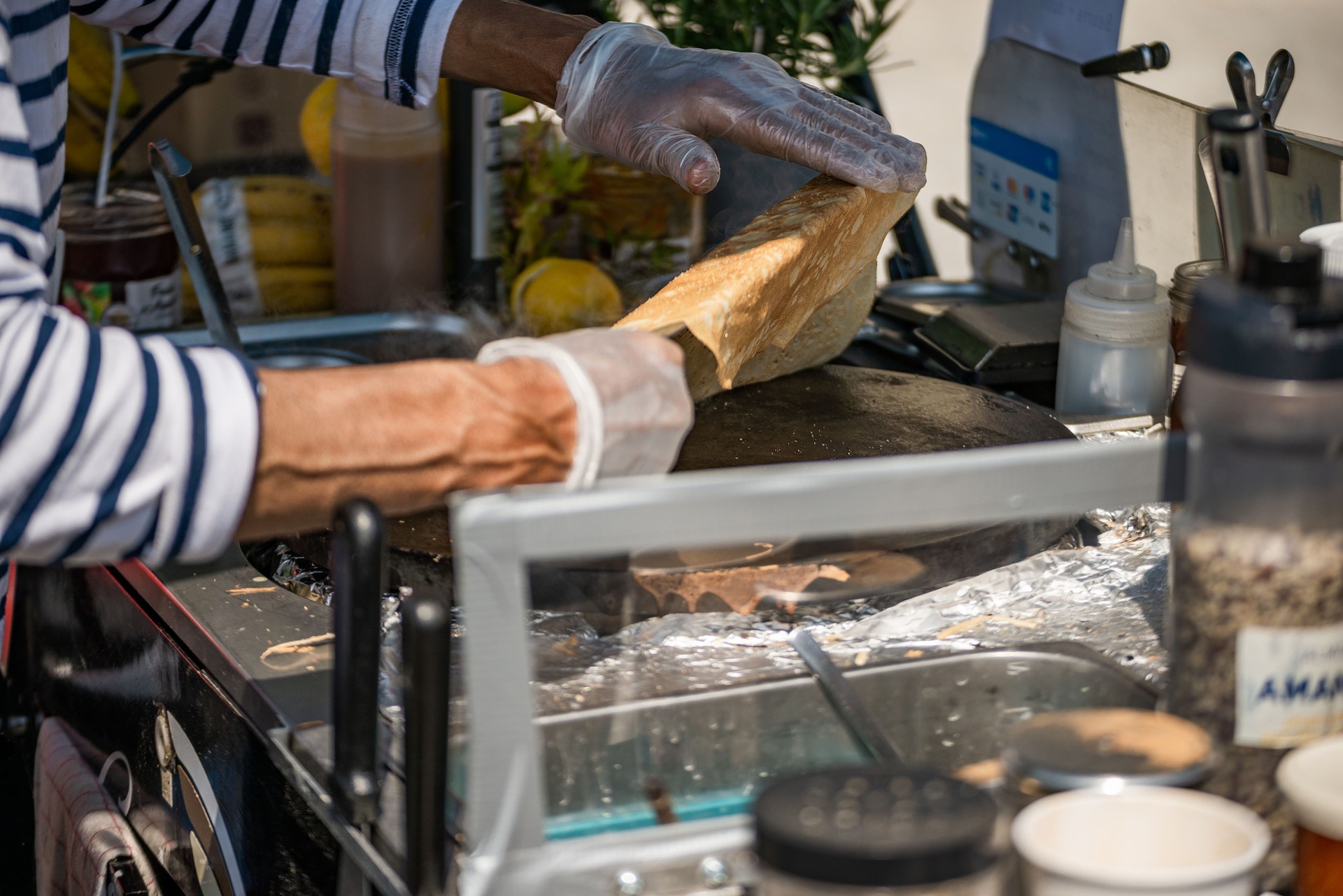 Man folding crêpe in street stall - Paris, France